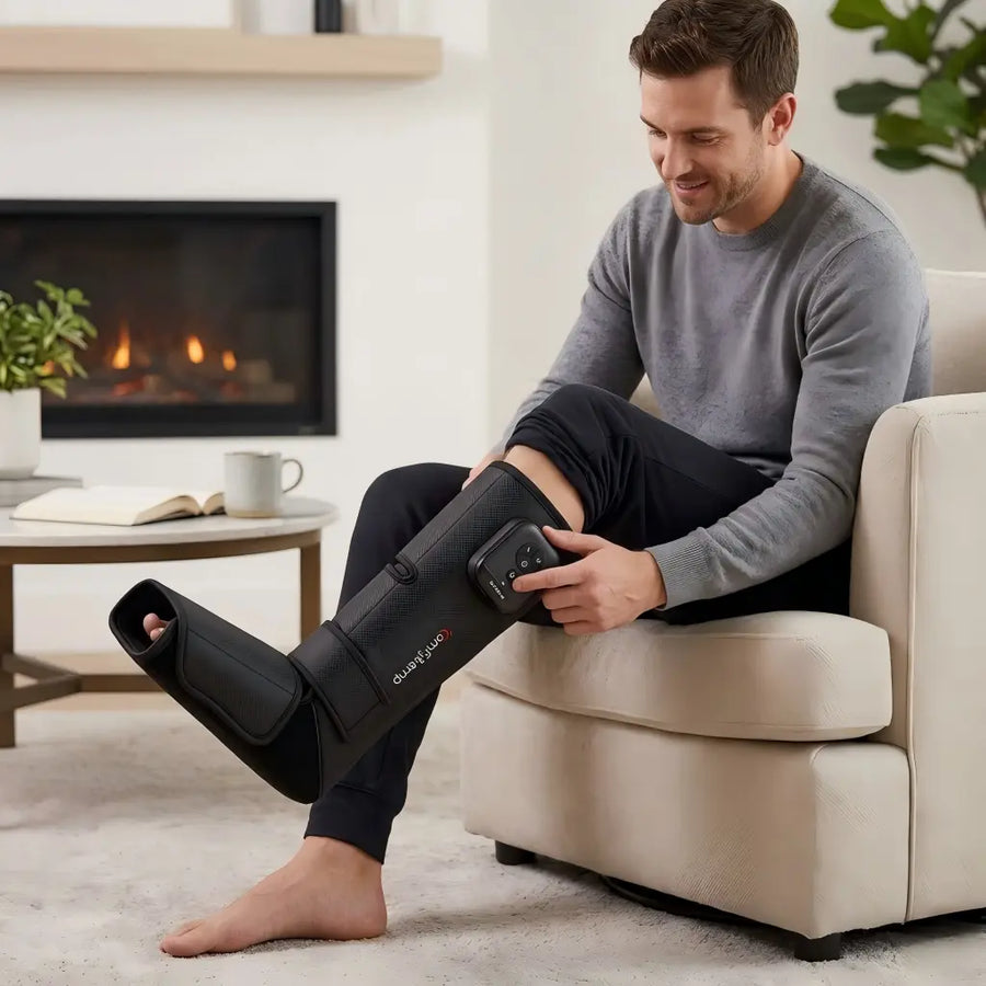 A man using a leg massager at home.