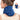 Woman wearing a blue plush neck heating pad with an inset showing it worn as a scarf.