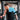A man lifts weights in a gym while wearing a blue shoulder ice pack wrap as a natural remedy.