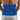Rear view of a man wearing a blue plush microwavable heating pad on his lower back.