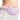 A woman wearing a purple menstrual heating pad with red vibration and heat waves on her abdomen.