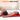 Man lying on a large red light therapy mat for back relief with text larger area better relief.