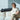 Senior woman on a sofa wearing a cordless arm massager for recovery.