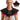 A blonde woman wearing a black Comfytemp heated neck and shoulder wrap with red light therapy.