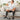 Man drinking water while wearing leg compression massagers after a workout.