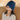 Woman wearing a blue plush weighted heating pad over her eyes and head for migraine relief.