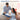 A man giving a boxed microwaveable heating pad to a happy woman in a room with heart balloons.