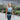 Woman walking outdoors while wearing a black wireless heating pad around her waist.