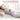 A woman sleeping comfortably wearing a purple heating pad with three timer setting icons displayed.