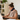 Woman working on a laptop while wearing a red light therapy neck wrap for pain relief.