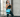 A woman in athletic wear wearing a blue gel ice pack wrap on her hip in a gym setting.