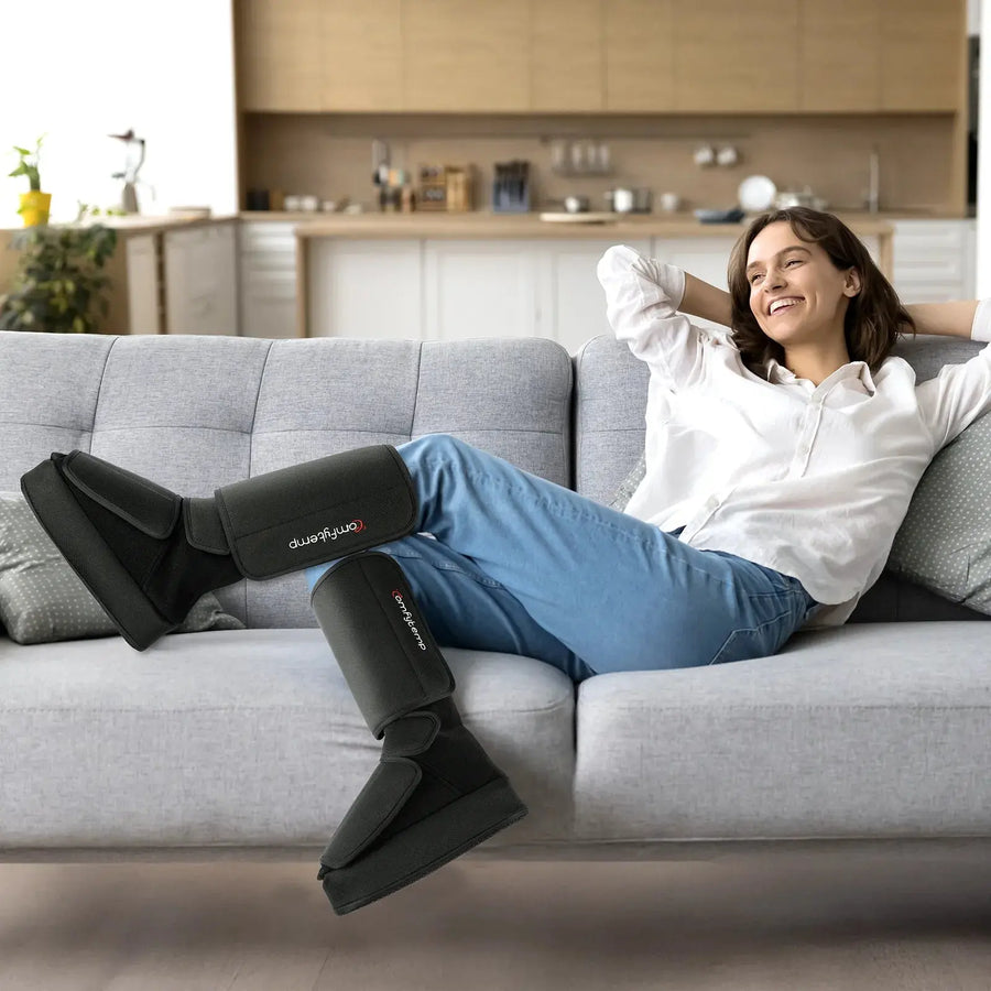 Woman relaxing on sofa using leg massager boots