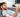 Man using TENS unit on arm while on phone