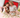 Mother and daughter using a red light therapy mat in bed surrounded by flowers.