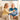 Blue quilted neck and waist heating pad worn by an older man on a couch
