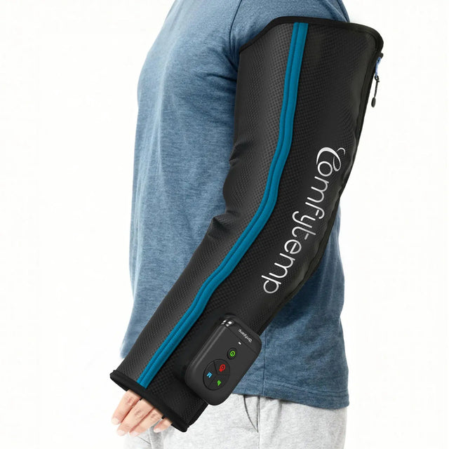 Man wearing a black cordless arm massager with a blue zipper and digital controller.
