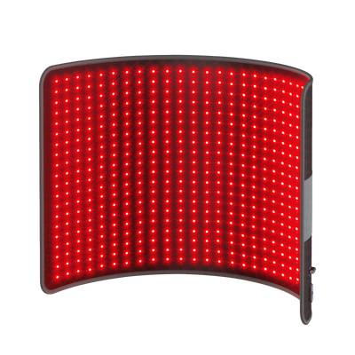 Flexible red light therapy pad with a grid of glowing red LED lights on a dark background.