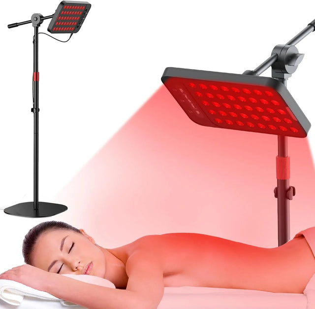 Woman lying down receiving red light therapy from an adjustable floor lamp device.
