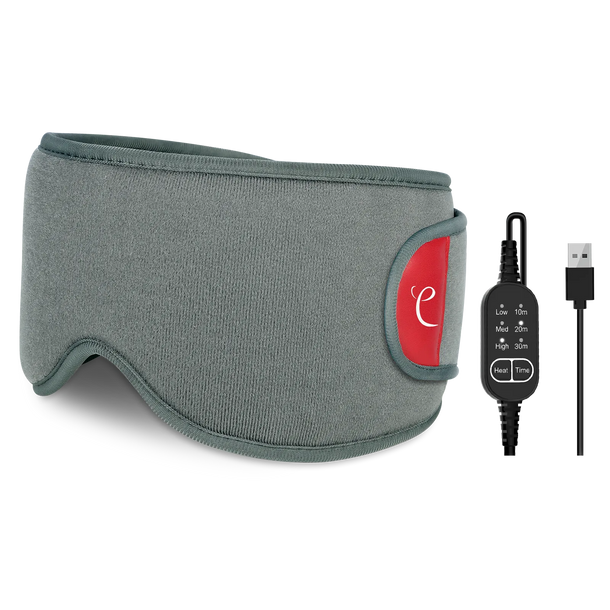 A grey heated sleep mask with a red logo tab and a USB control cable showing heat and time settings.