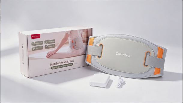 Comfytemp portable heating pad belt in gray with orange accents, shown next to its product box, battery pack
