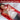 A woman lying on a red light therapy mat, highlighting benefits like pain relief and reduced inflammation.