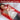 Woman relaxing on a red light therapy mat, showcasing benefits like pain relief and healing.